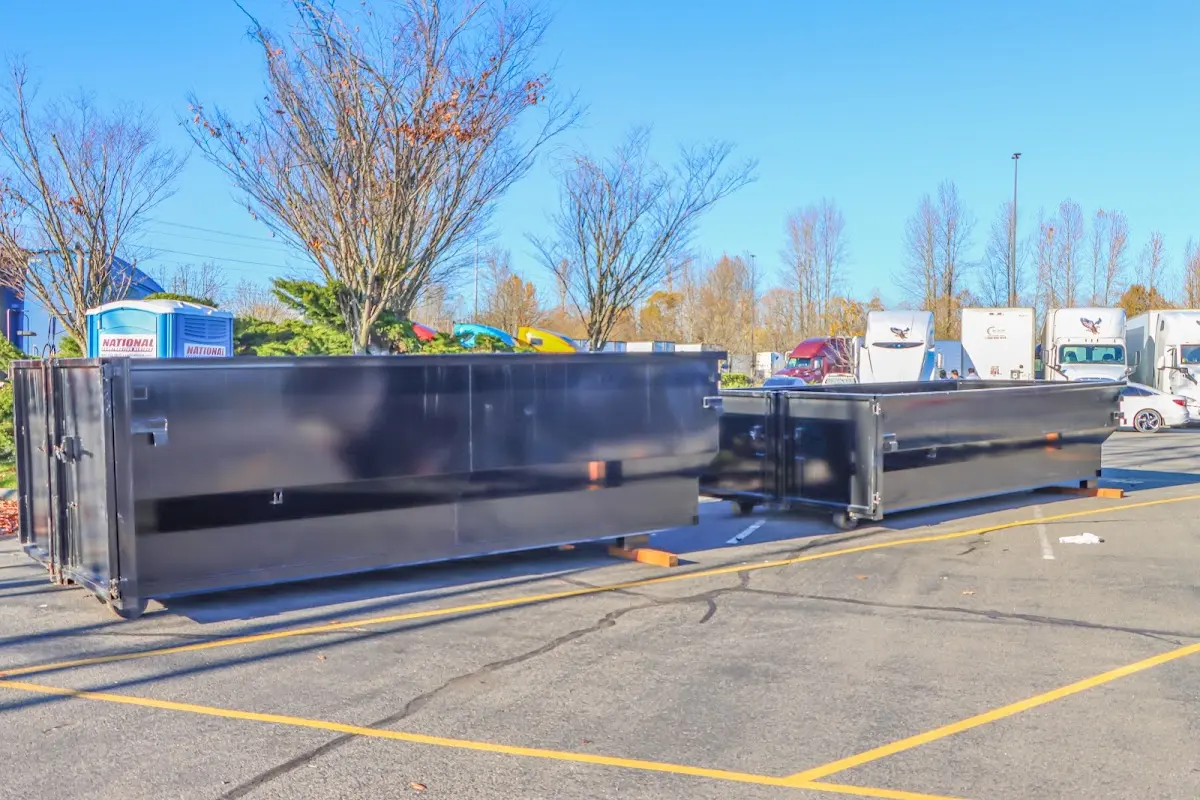 Professional dumpster rental service with roll-off container on residential driveway in Yazoo City